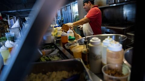 The economy is starting to cool — but the job market is 'like an inferno' | CNN Business - NewsOpener A restaurant worker prepares a sauce at a tavern in Washington, D.C.