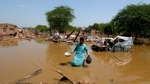 A man looks for salvageable belongings from his flooded home on September 1, 2022.