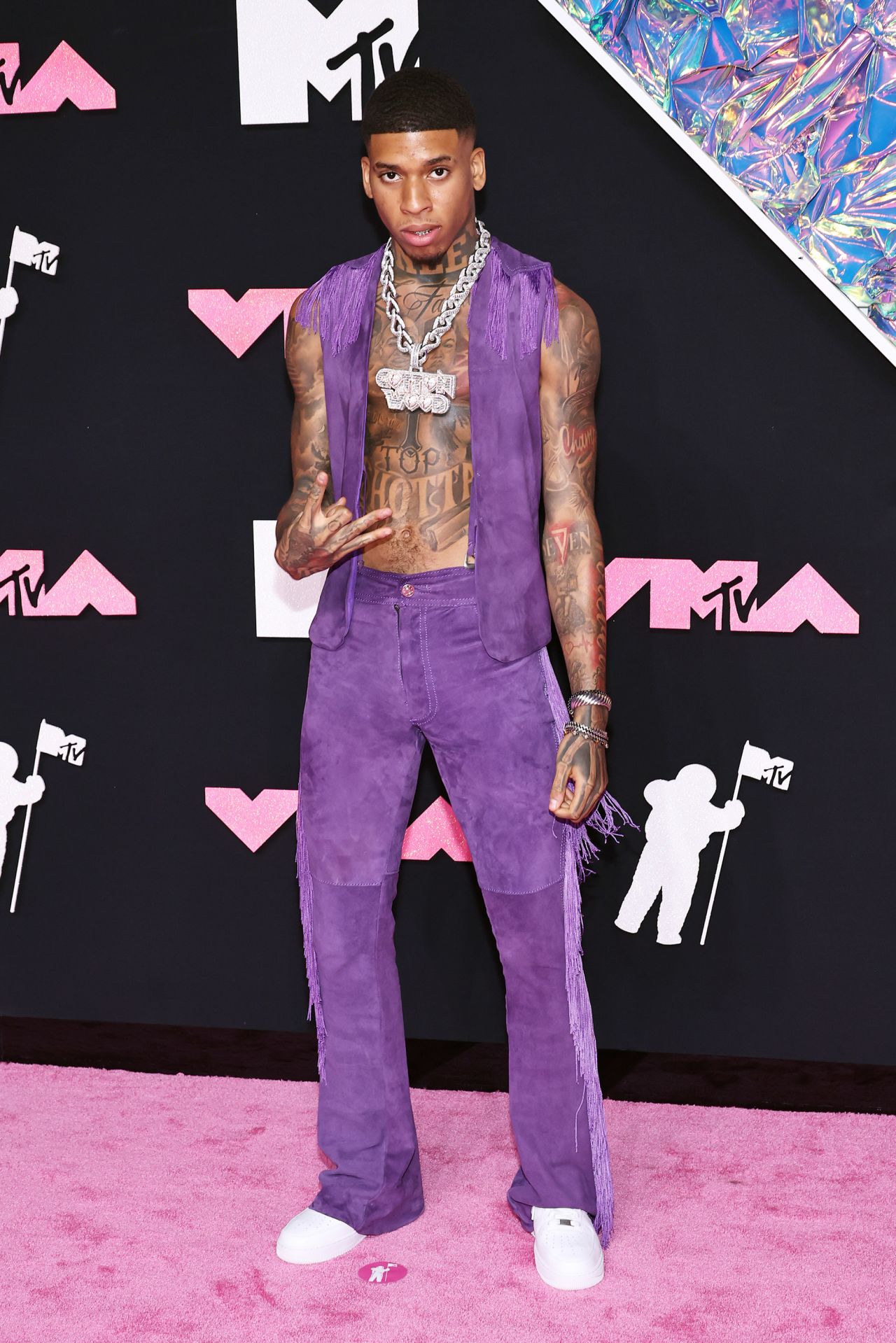 NLE Choppa went for cowboy chic with a purple fringed suede two-piece and a heavy bejeweled