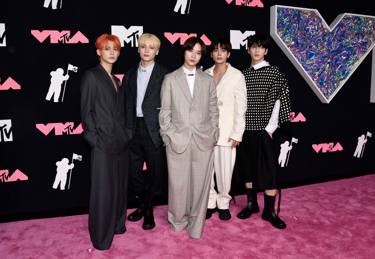 South Korean boy band Tomorrow x Together, attending their first VMAs, looked dapper in a variety of black, white and tan looks.