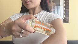 Woman applying body oil