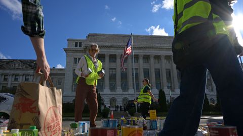 Furlogh federal workers and volunteers collect groceries during the People's Pantry Food drive to replenish food banks ahead of SNAP lapse at the USDA Headquarters, in the National Mall, Washington, DC on October 30, 2025.