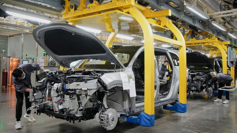 This photo taken on March 27, 2024 shows employees working on a car assembly line at a factory of Chinese carmaker Li Auto in Changzhou, in eastern China's Jiangsu province.