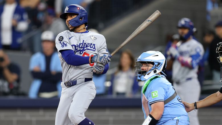 TORONTO, ONTARIO - OCTOBER 31: Mookie Betts #50 of the Los Angeles Dodgers hits a two-run single against Kevin Gausman #34 of the Toronto Blue Jays during the third inning in game six of the 2025 World Series at Rogers Center on October 31, 2025 in Toronto, Ontario.  (Photo by Emilee Chinn/Getty Images)