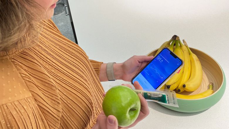 Meg Tirrell tracks her glucose before eating a snack in New York City, on November 22.