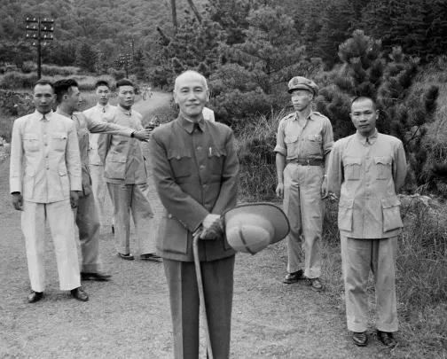 (Original caption) July 13, 1949 - Caoshan, Taiwan: President Chiang Kai-shek takes a recent photo with his bodyguard in the background. Chiang Kai-shek is currently in the Philippines to discuss an anti-communist pact in the Pacific with President Elpidio Quirino.