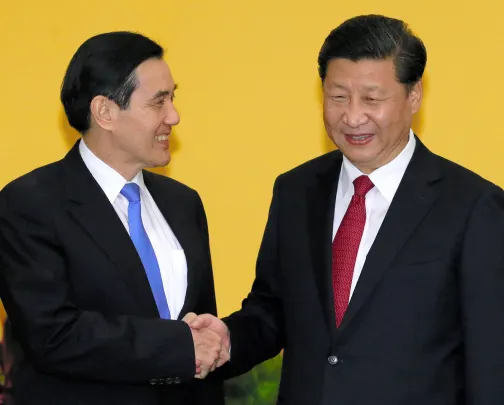 Chinese President Xi Jinping (right) and Taiwanese President Ma Ying-jeou (left) shake hands before meeting at a hotel in Singapore on November 7, 2015.