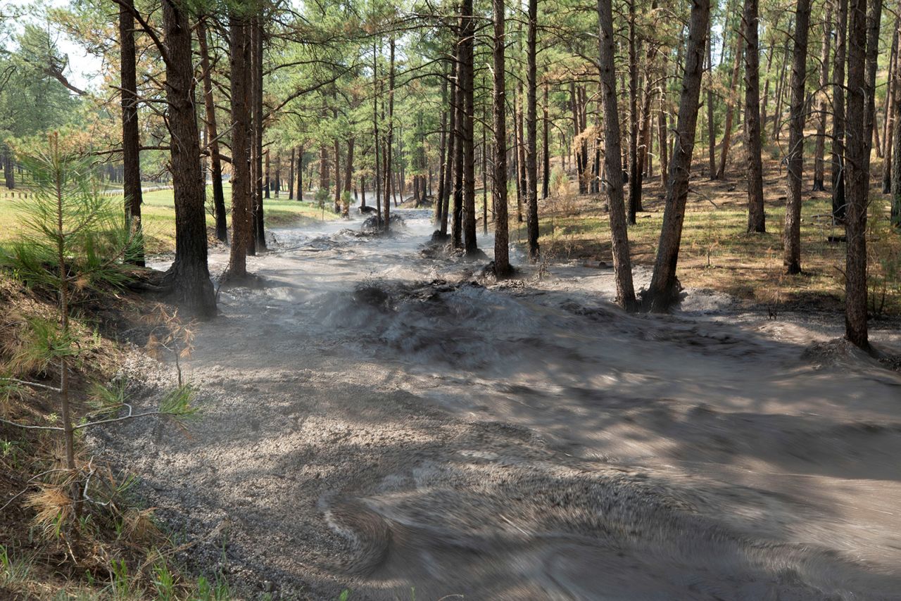 Flash flooding carrying debris, ash and hail through Cedar Creek as the South Fork Fire continues to burn in Ruidoso, New Mexico, on June 19. 