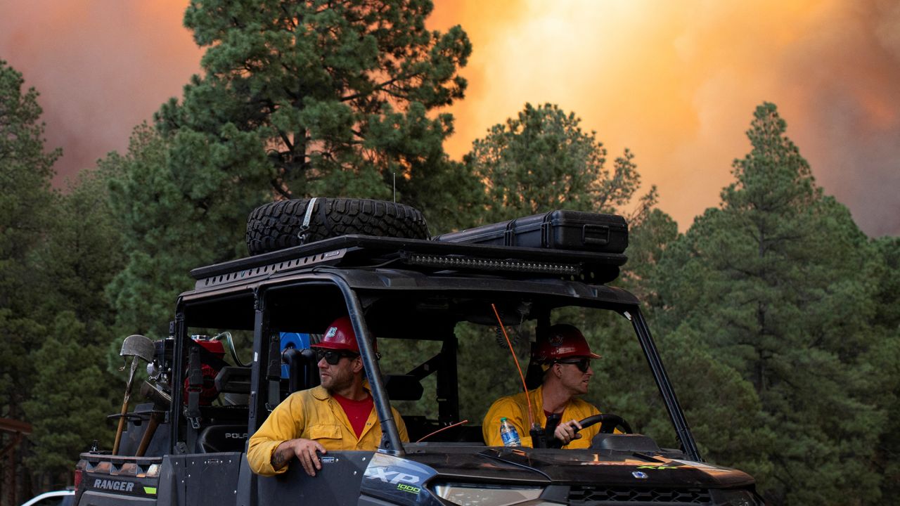 USDA Forest Service firefighters return from battling the blaze and assisting with evacuations caused by the South Fork Fire in Ruidoso, New Mexico, on June 17.