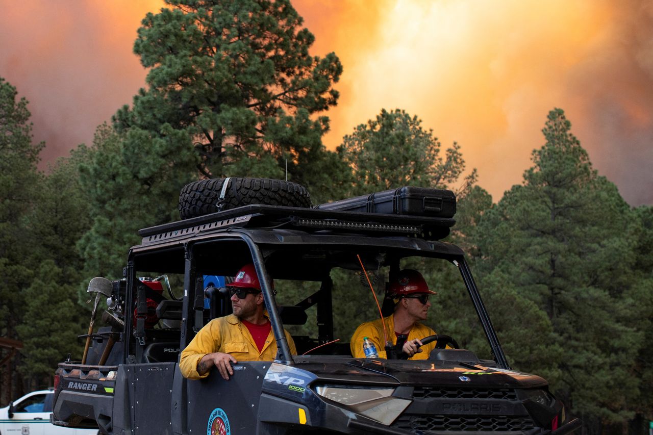 USDA Forest Service firefighters return from battling the blaze and assisting with evacuations caused by the South Fork Fire in Ruidoso, New Mexico, on June 17.