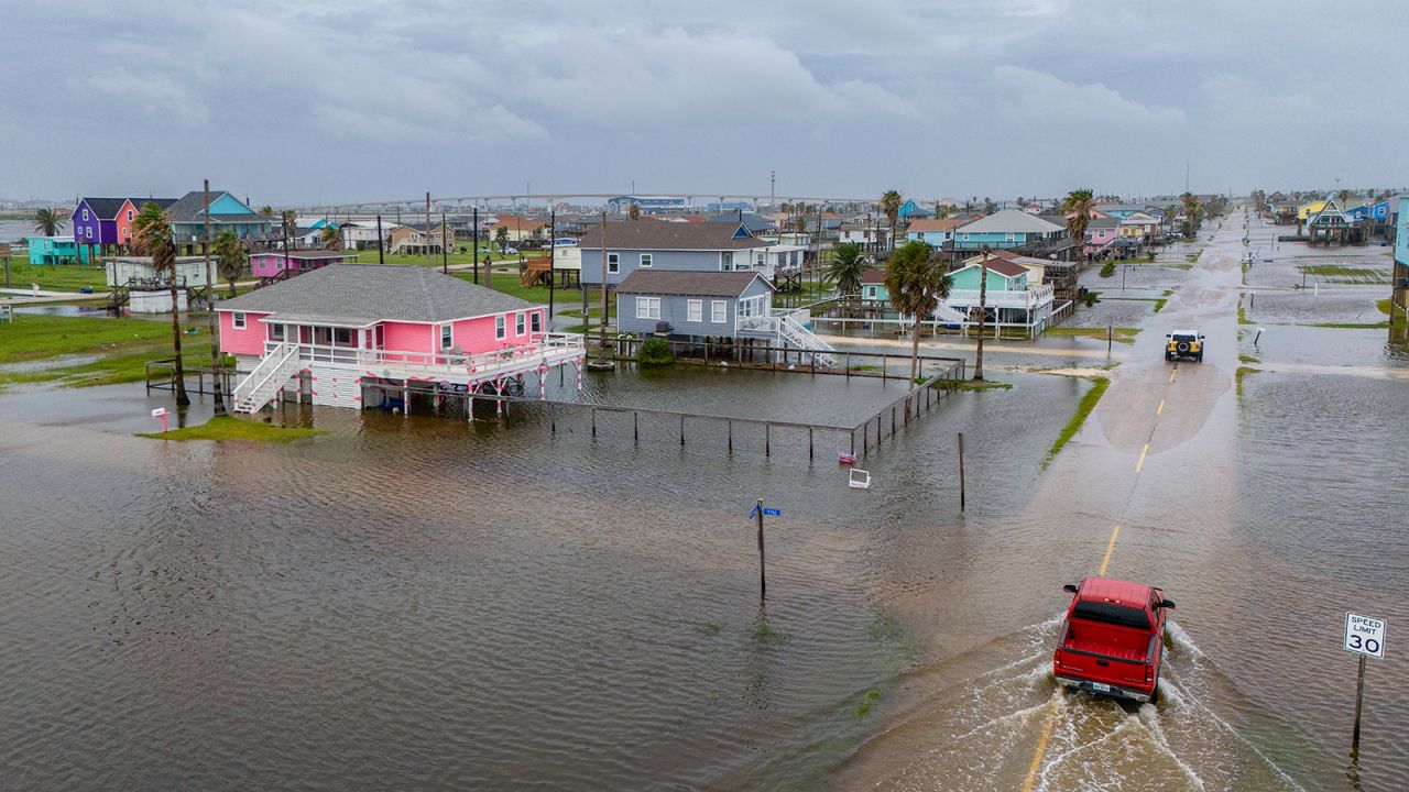 Vehicles drive through flooded neighborhoods in Surfside Beach, Texas on June 19.