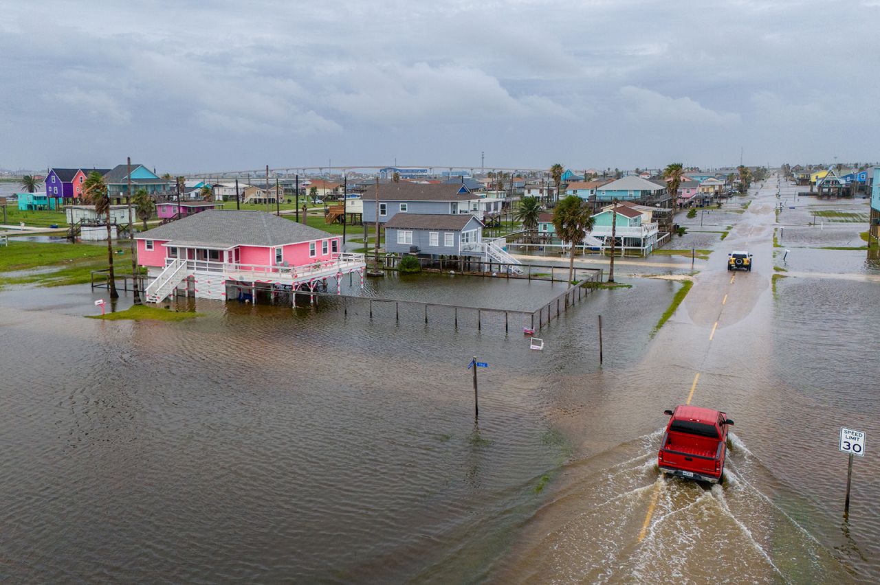 Vehicles drive through flooded neighborhoods in Surfside Beach, Texas on June 19.