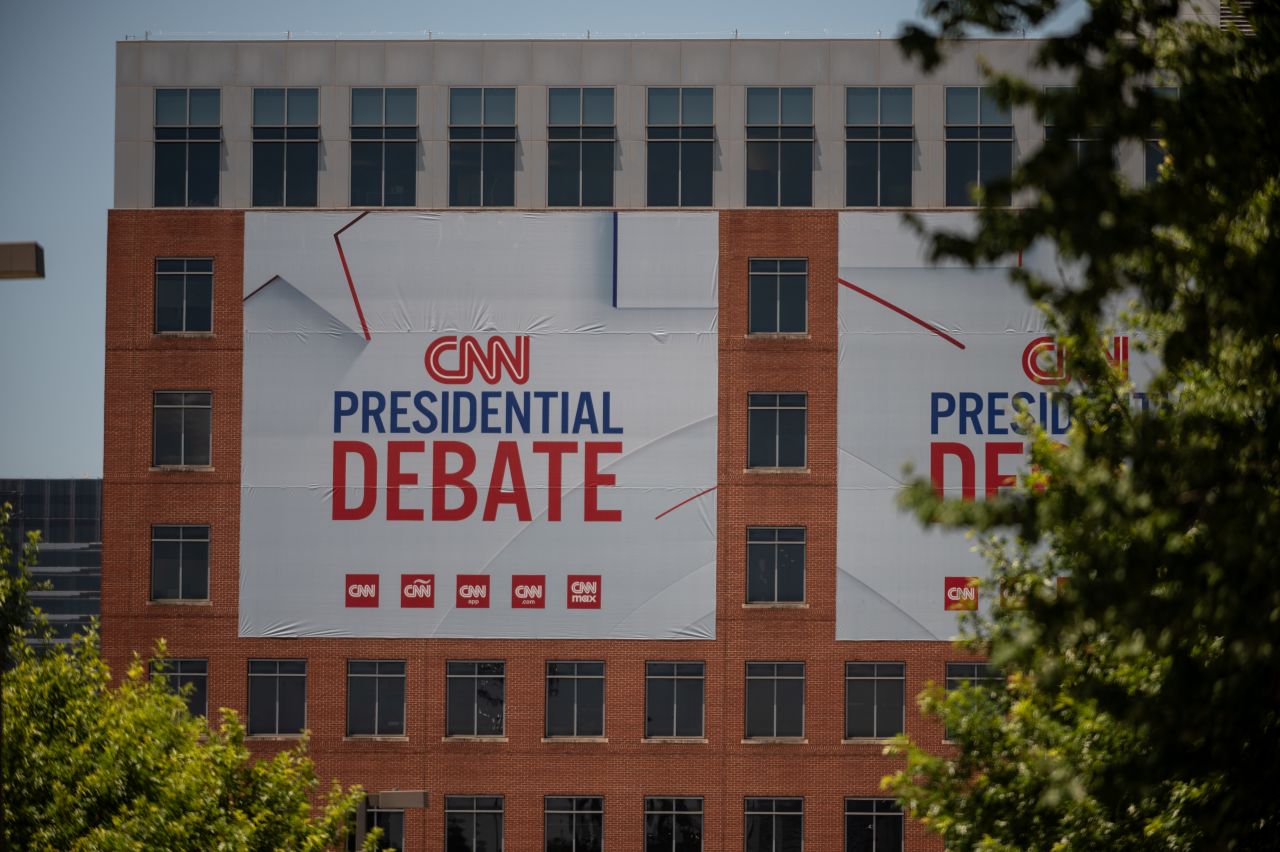 Banners hang outside of CNN’s Atlanta headquarters ahead of CNN’s Presidential Debate between President Joe Biden and former President Donald Trump on Monday, June 24.