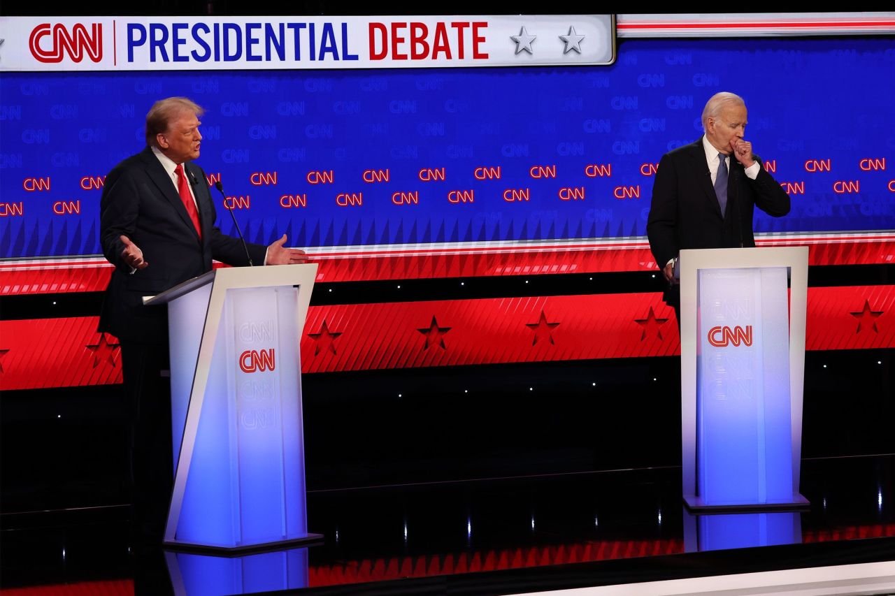 President Joe Biden coughs, while former President Donald Trump speaks during the CNN presidential debate on June 27.