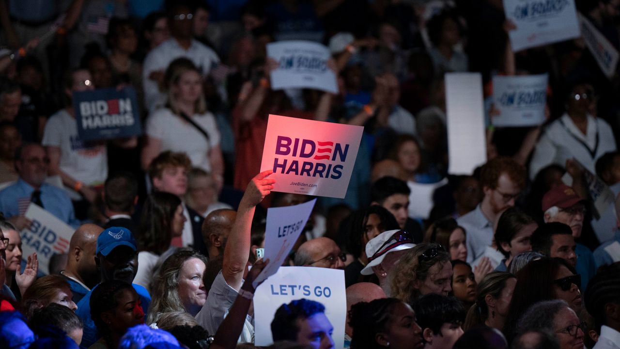 People wave signs at a post-debate campaign rally for President Joe Biden on June 28, in Raleigh, North Carolina. 