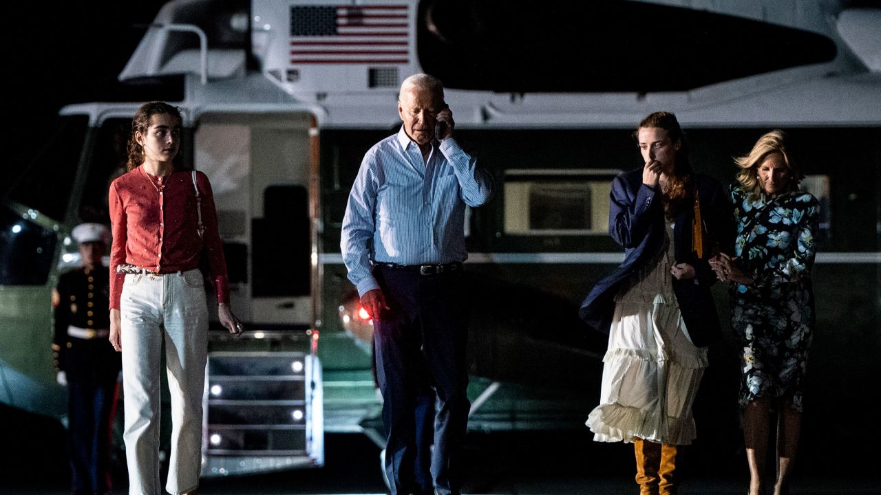 President Joe Biden talks on the phone as he and first lady Jill Biden, with their granddaughters Finnegan and Natalie Biden, depart Burlington County, New Jersey, after campaign receptions in New York and New Jersey, on Saturday, June 29, 2024. 