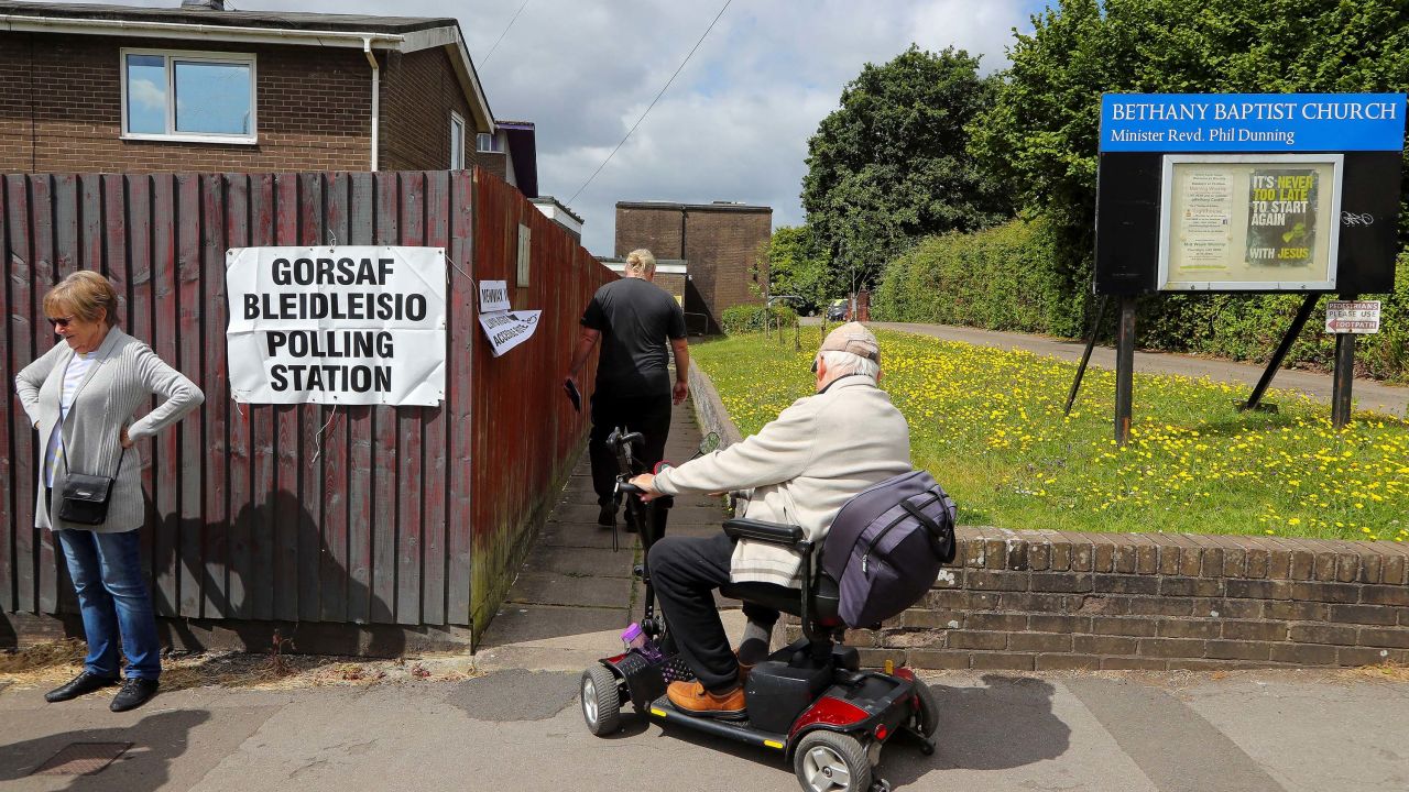 Voters enter a polling station in Rhiwbina, north of Cardiff, Wales, on July 4.