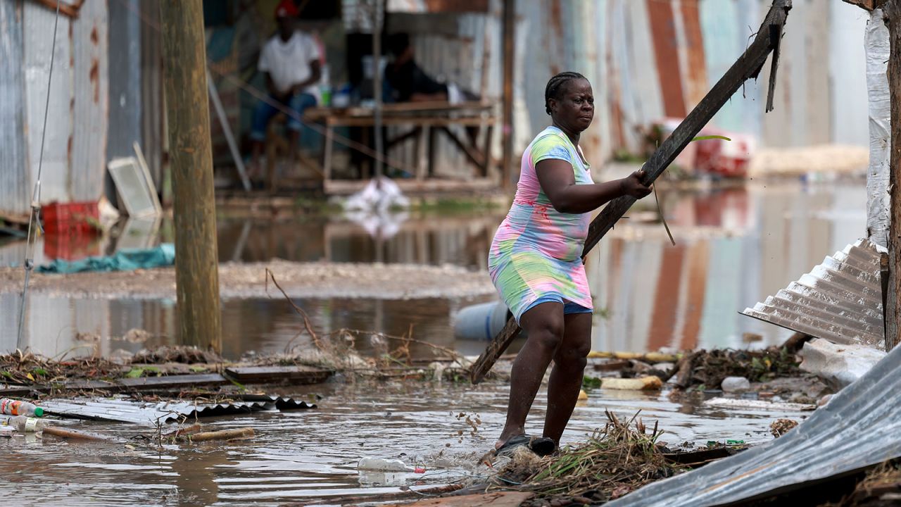 Simone Francis gathers items from her home that were blown away as Hurricane Beryl passed through the area on Thursday in Old Harbor, Jamaica. 