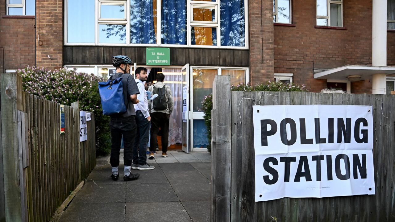 People queue to vote at a polling station in London on July 4, as Britain holds a general election. 