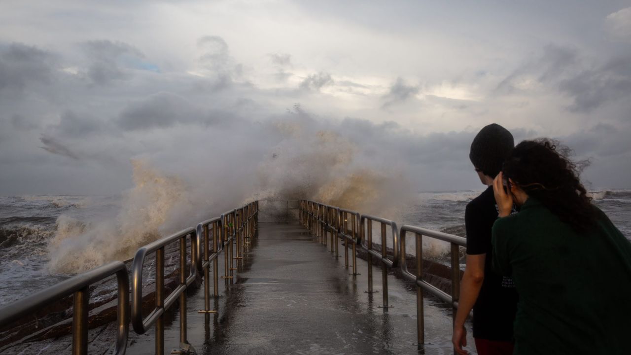 People watch as large waves created by Hurricane Beryl crash into the Packery Canal Pier Sunday evening, July 7, in Corpus Christi, Texas.