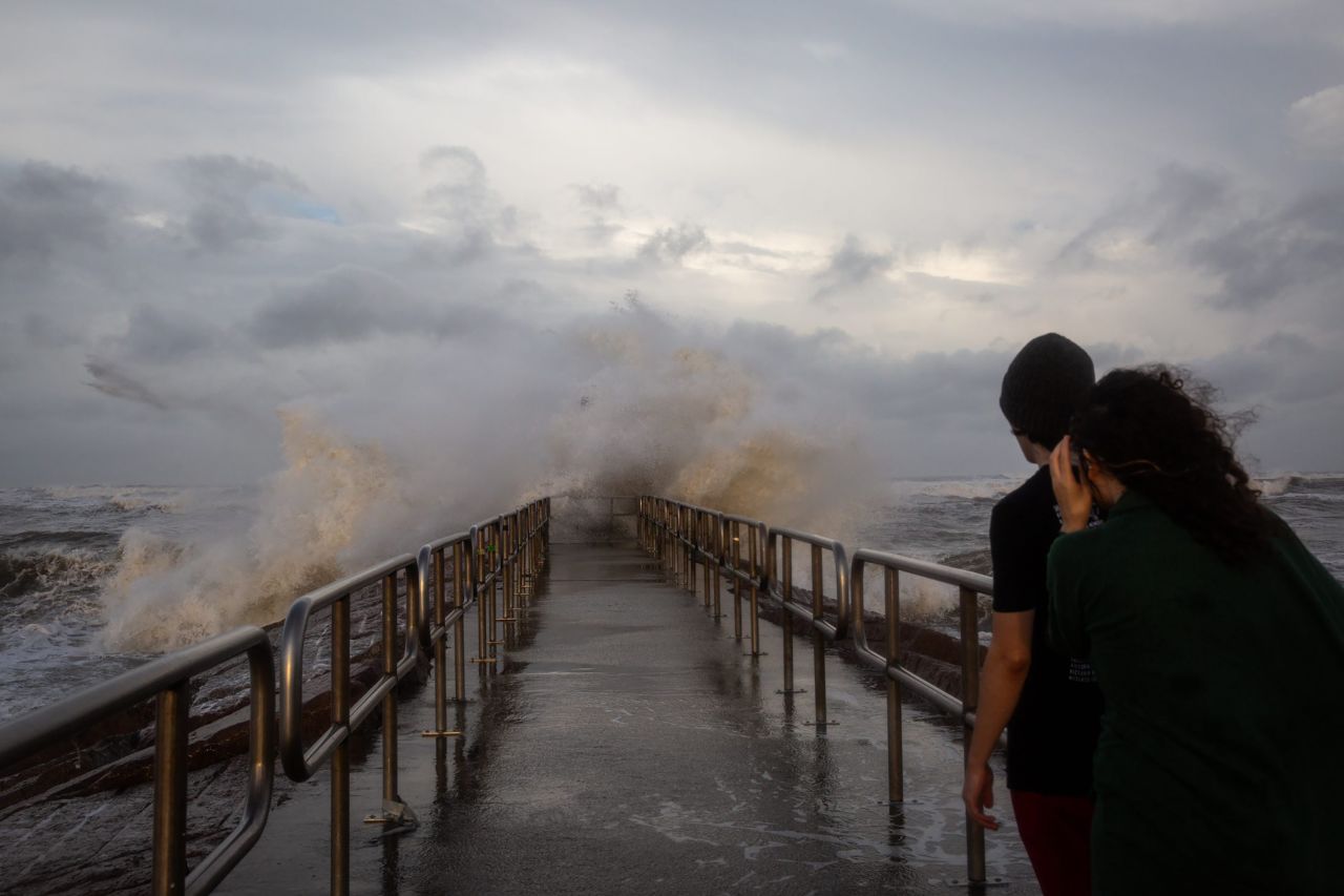 People watch large swells created by Hurricane Beryl crash over the Packery Channel Jetty on Sunday evening, July 7, in Corpus Christi, Texas.