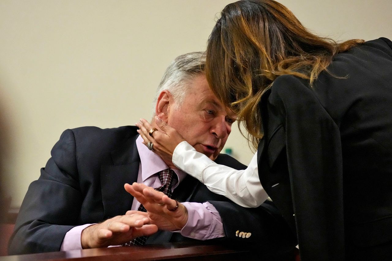 Alec Baldwin interacts with his wife Hilaria Baldwin before court starts on Wednesday, July 10, in Santa Fe, New Mexico. 