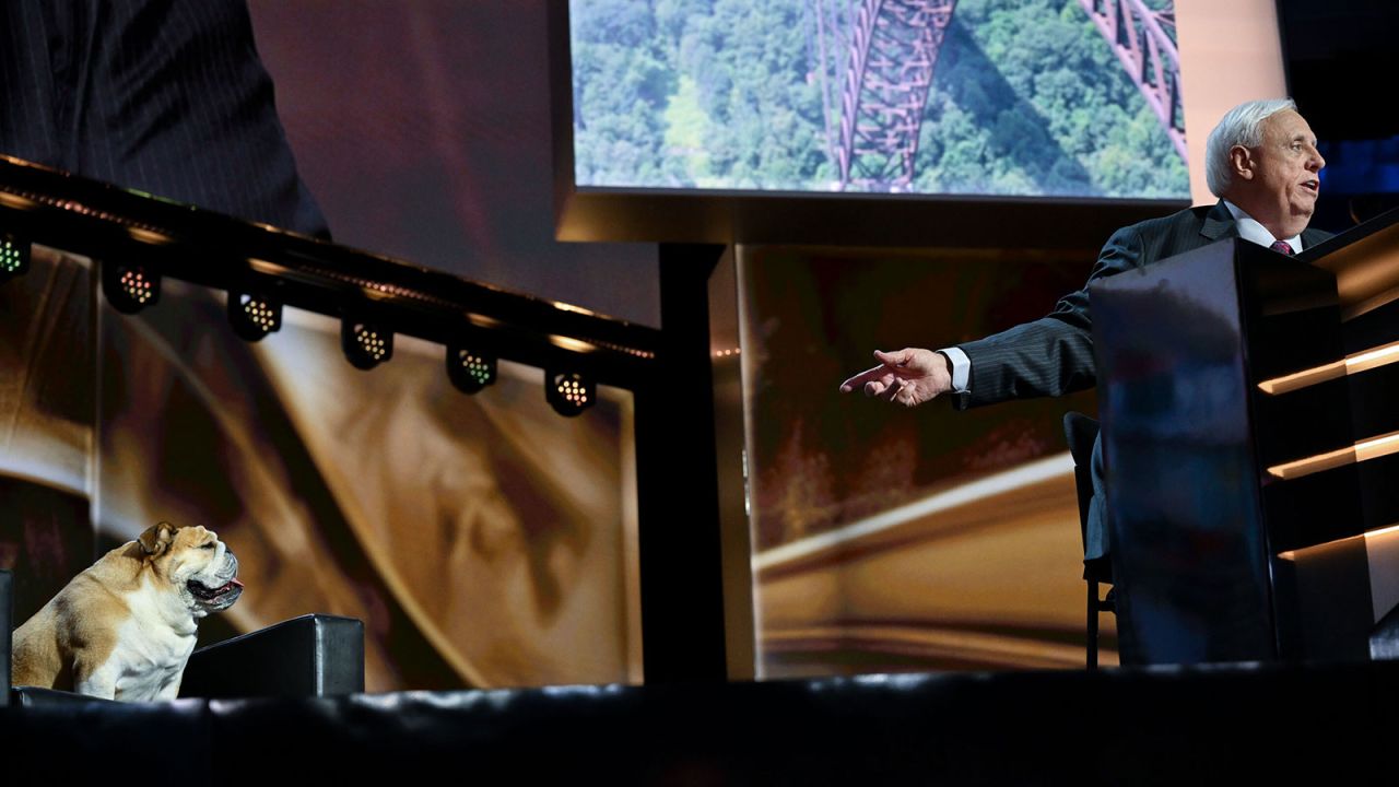 West Virginia Gov. Jim Justice speaks on stage, accompanied by his dog, Babydog, on stage during the second day of the convention on Tuesday, July 16.