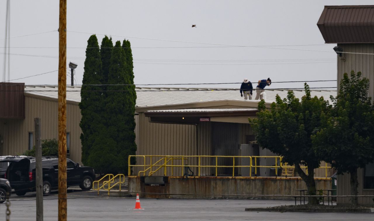 Two FBI investigators scan the roof from which alleged the shooter fired at former President Donald Trump on July 14 in Butler, Pennsylvania.