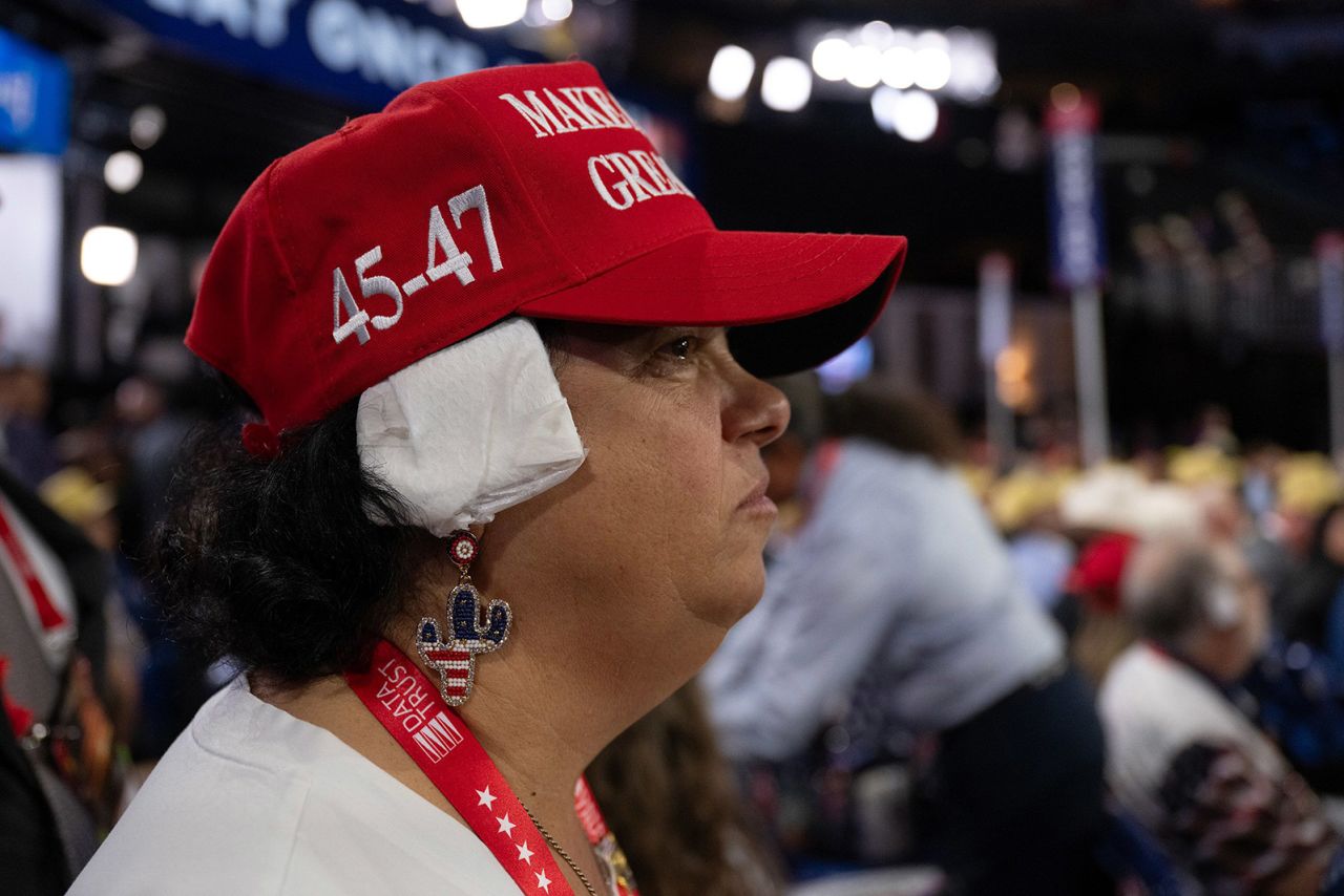 Stacey Goodman, a delegate from Arizona, wears a bandage on her ear in solidarity with Trump.