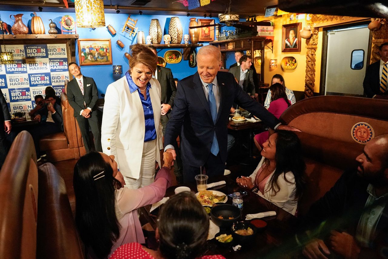 President Joe Biden, alongside Maritza Rodriguez, a campaign advisor for the Biden Nevada state team, greets people as he arrives at a restaurant ahead of a radio interview in Las Vegas, Nevada, on July 17.