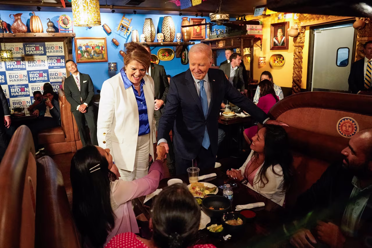 President Joe Biden, alongside Maritza Rodriguez, a campaign advisor for the Biden Nevada state team, greets people as he arrives at a restaurant ahead of a radio interview in Las Vegas, Nevada, on July 17.