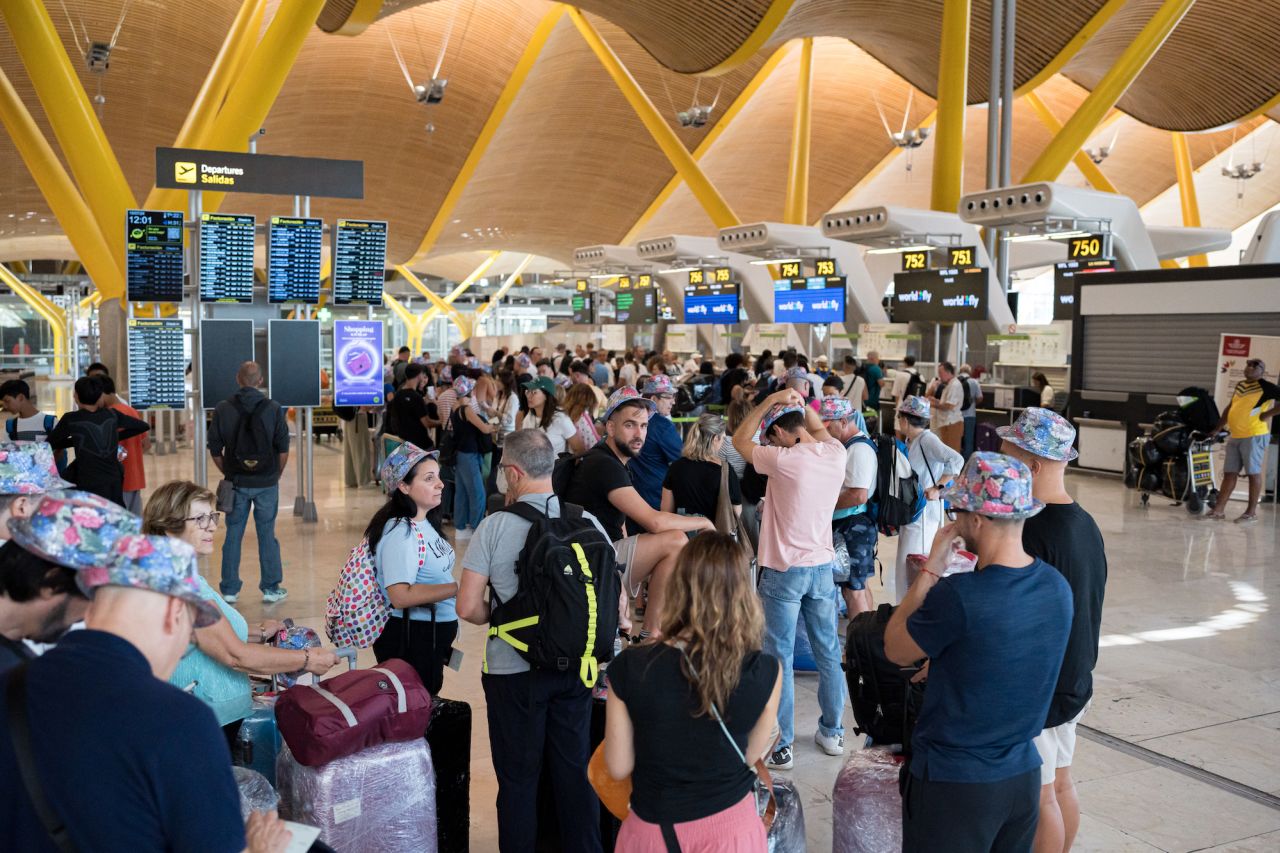 Passengers line up at Madrid-Barajas airport in Madrid.