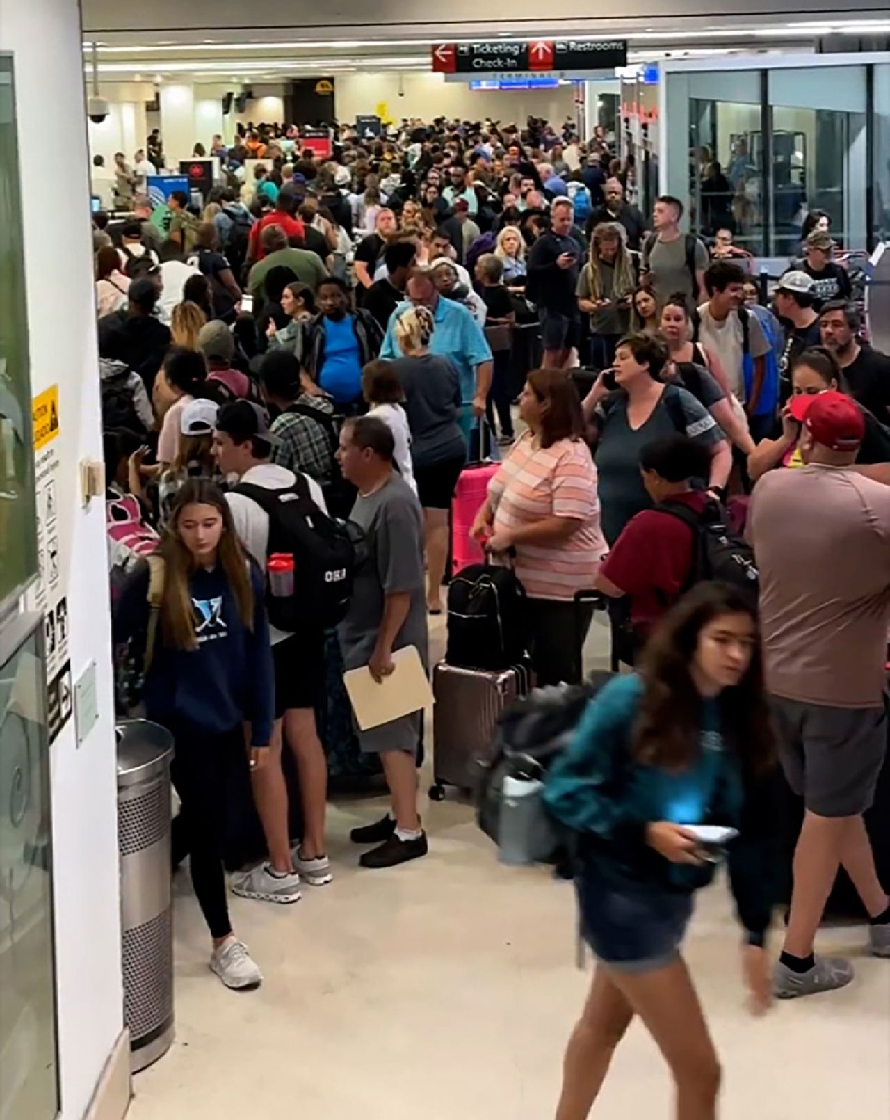 A screengrab from a video taken by William Sikora III shows travelers at the Philadelphia International Airport on Friday morning.