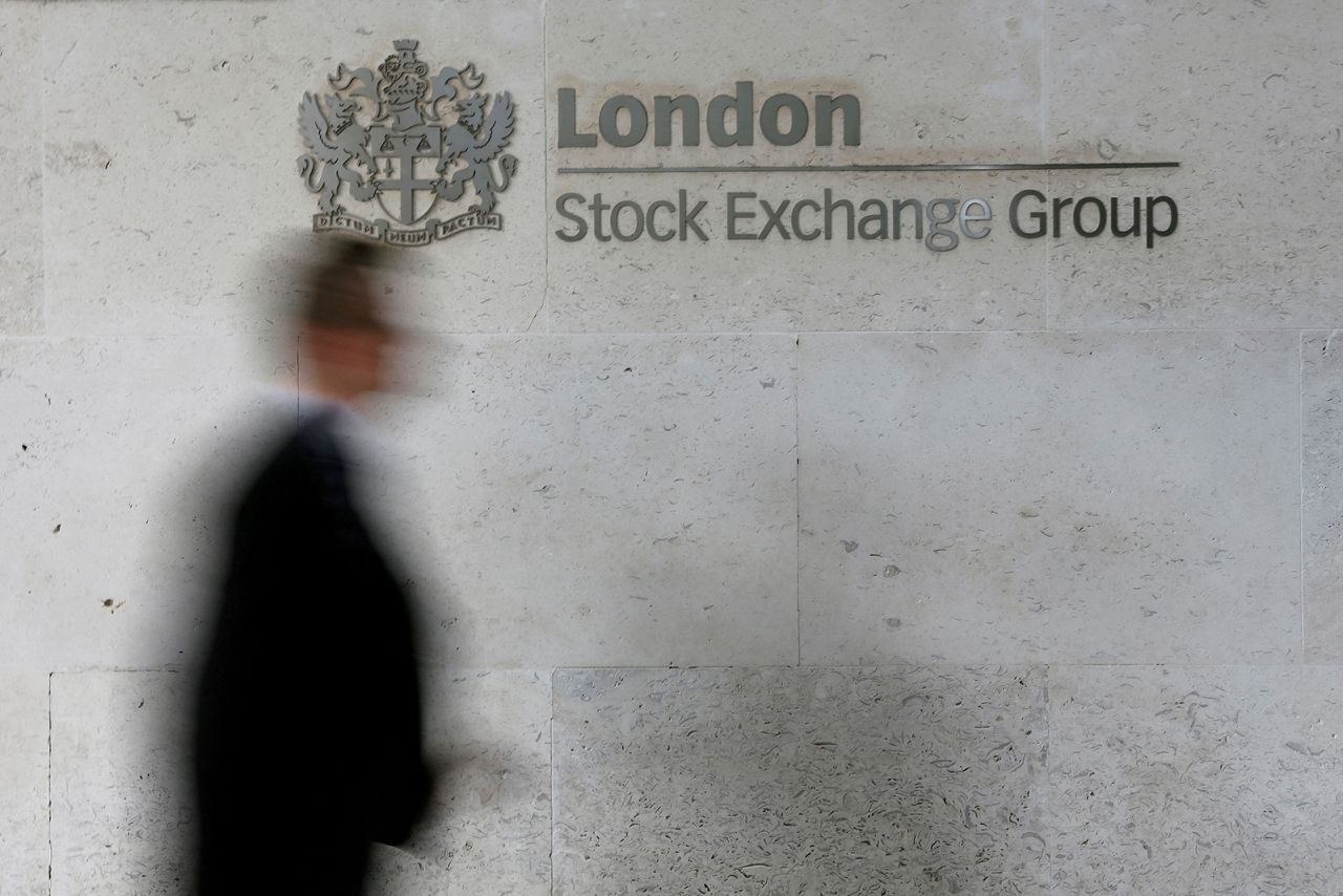 A man walks past the London Stock Exchange in 2013.