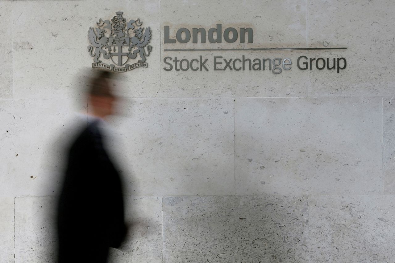A man walks past the London Stock Exchange in 2013.