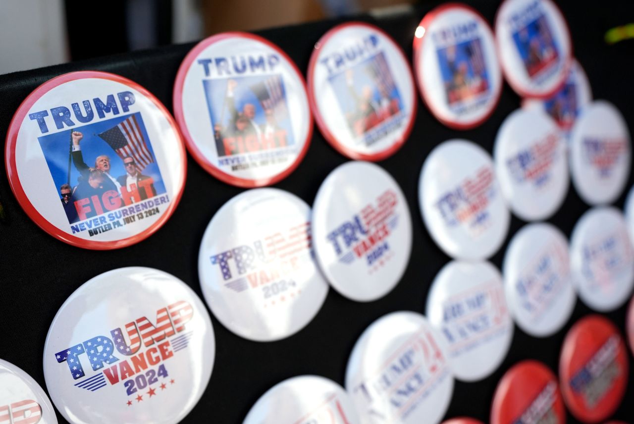 Pins showing an AP photo taken following the assassination attempt of ormer President Donald Trump are seen before a campaign event in Grand Rapids, Michigan, on July 20.