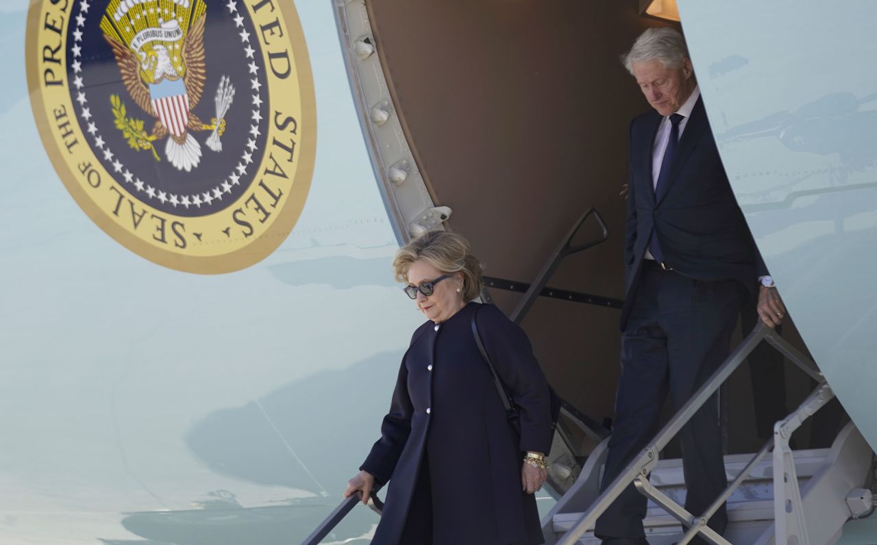 Former President Bill Clinton and former Secretary of State Hillary Clinton arrive at Dobbins Air Reserve Base in Marietta, Georgia, on November 28, 2023, to travel to Atlanta to attend at tribute service for former first lady Rosalynn Carter. 