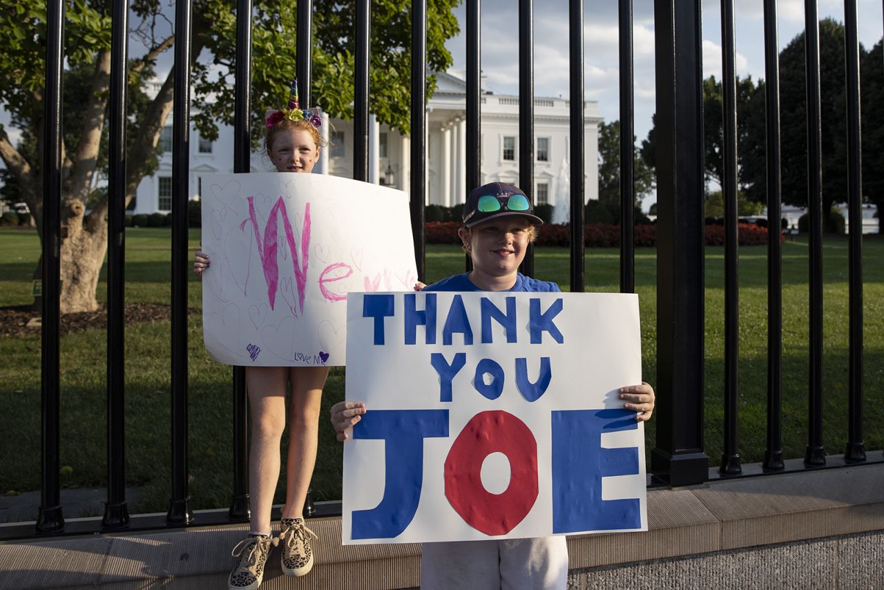 Children hold banners outside the White House after US President Joe Biden announced he was dropping out of the presidential election on July 21.