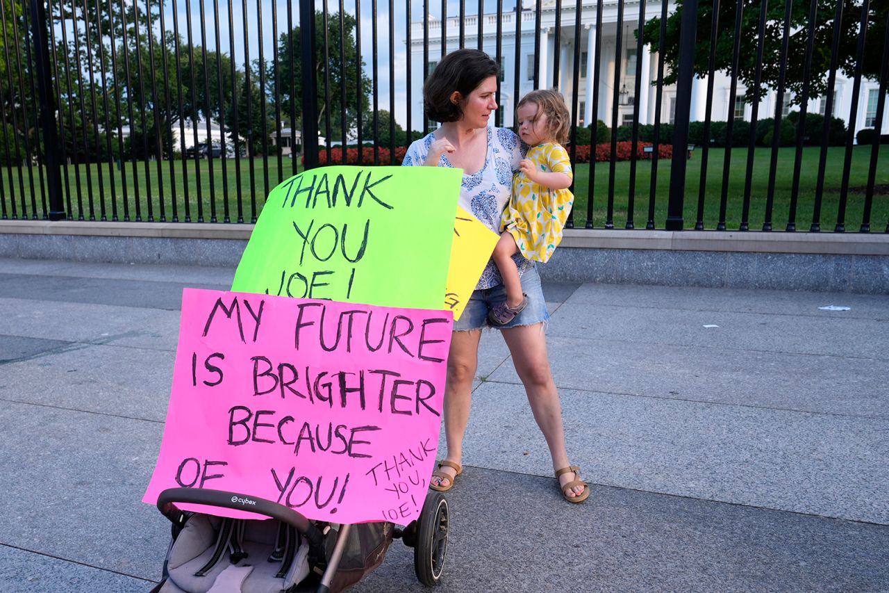 Anna Filipic, of Washington, DC, holds her daughter Louisa Monje, 2, outside the White House on July 21, as they show support for President Joe Biden.?