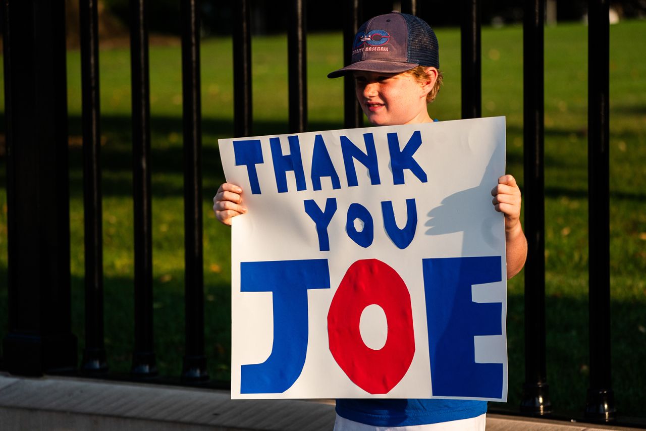 Hugh, 10, holds a thank-you sign outside of the White House on July 21.