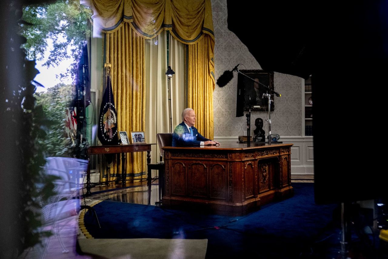 Biden, seen through a window, delivers his first-ever address from the White House Oval Office in June 2023. He declared bipartisanship alive and well, as he?pointed to the compromise?measure that raised the federal borrowing limit and avoided a catastrophic default.?