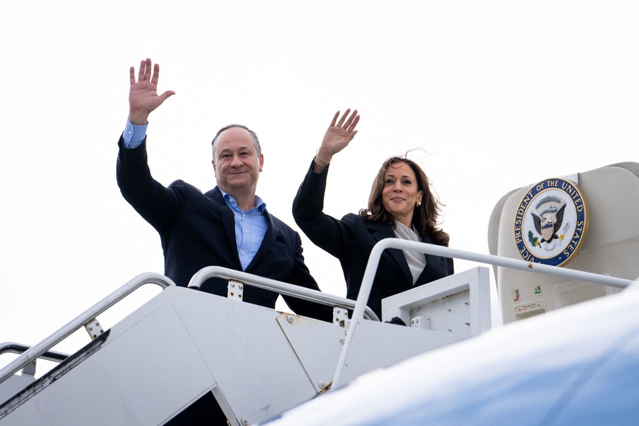 Vice President Kamala Harris and second gentleman Doug Emhoff wave as they board Air Force Two in New Castle, Delaware, on July 22.