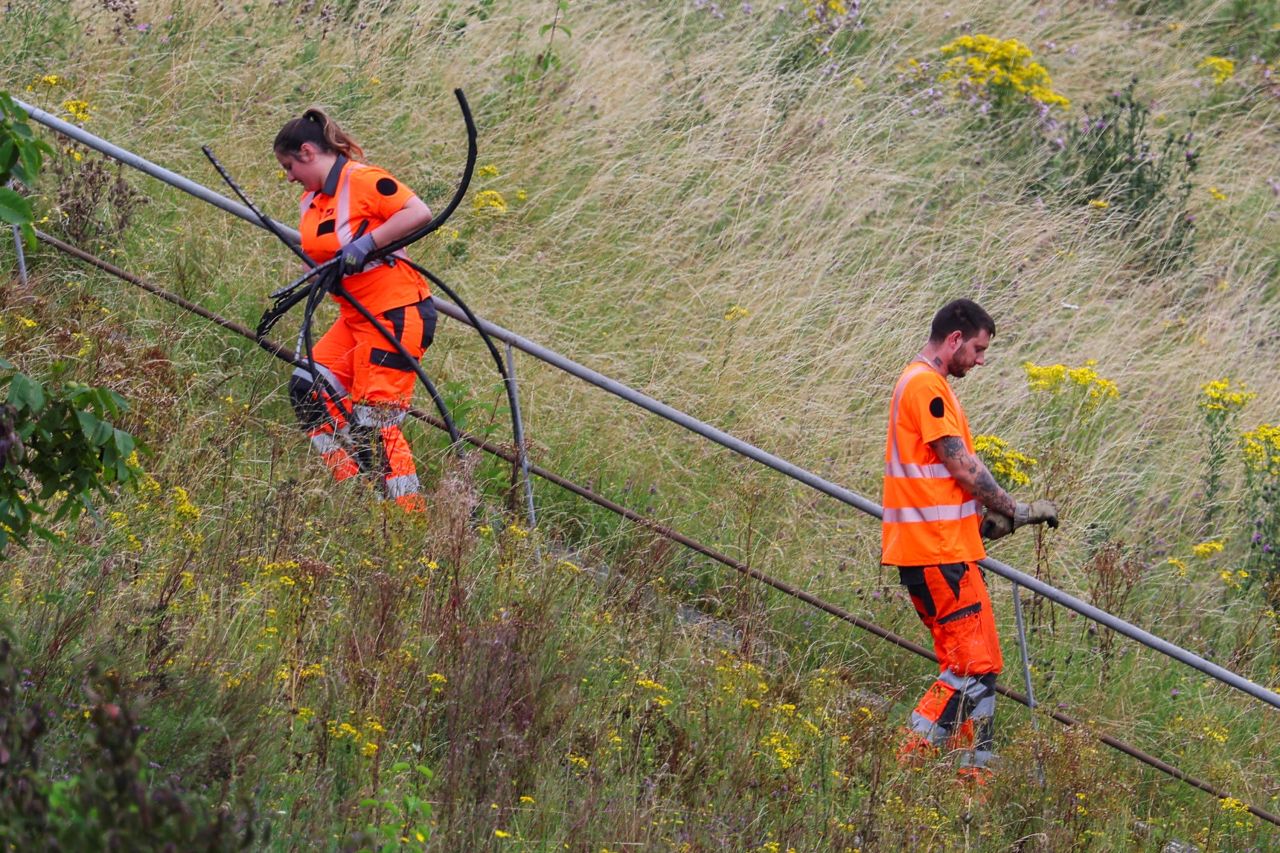 SNCF railway staff work at the site where France's high-speed train network was targeted with a series of coordinated actions that brought major disruption, in Croisilles, northern France?on July 26.