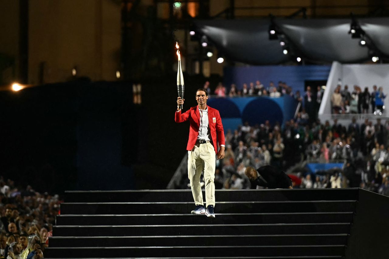 Spain's tennis player Rafael Nadal carries the Olympic flame.