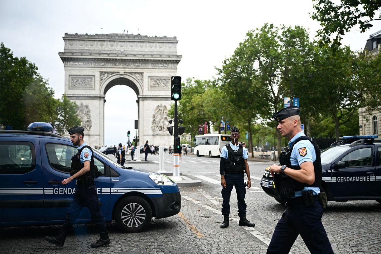 French Gendarmes patrol in front of the the Arc de Triomphe a few hours prior to the start of the opening ceremony of the Paris 2024 Olympic Games in Paris on July 26.