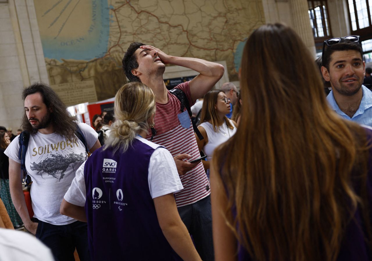 Passengers react to threats against the French high-speed train network TGV at the Gare de Bordeaux Saint-Jean station in Bordeaux, France, on Friday, July 26.