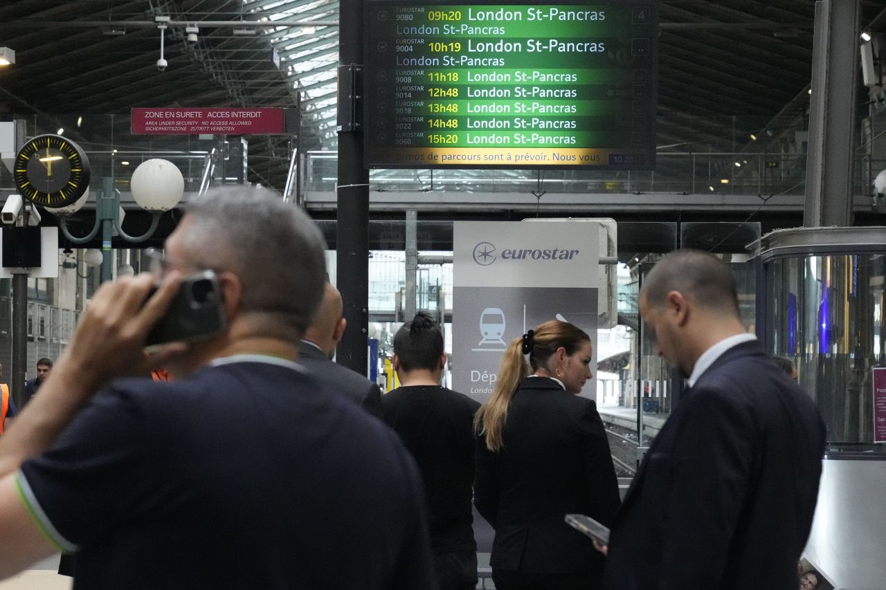 Travellers wait at the Eurostar platform inside the Gare du Nord train station in Paris, amid service disruptions, on July 26. 