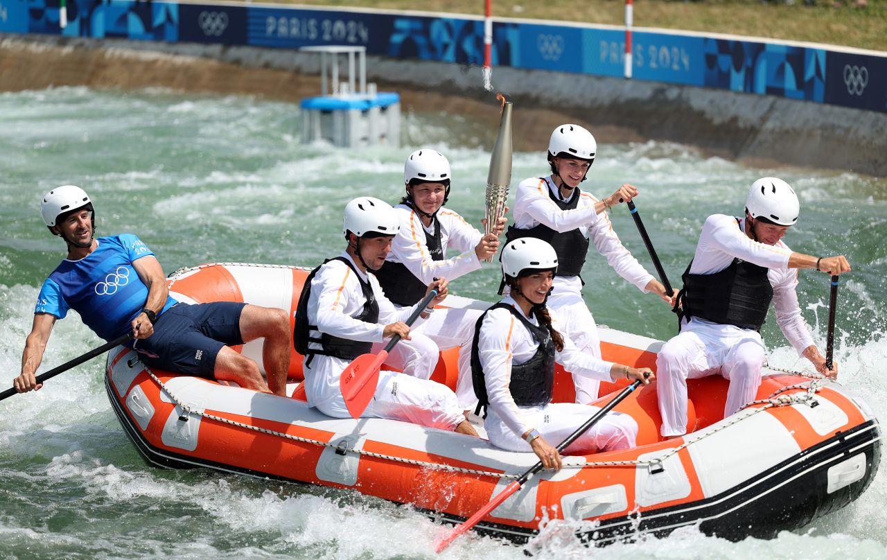 The Olympic Torch is carried down the Canoe Slalom course at Vaires-Sur-Marne Nautical Stadium in Paris on July 20. 