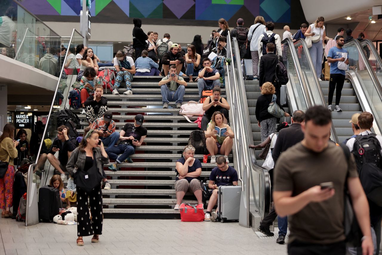 Passengers wait for train departures at the Gare Montparnasse train station in Paris on July 26.