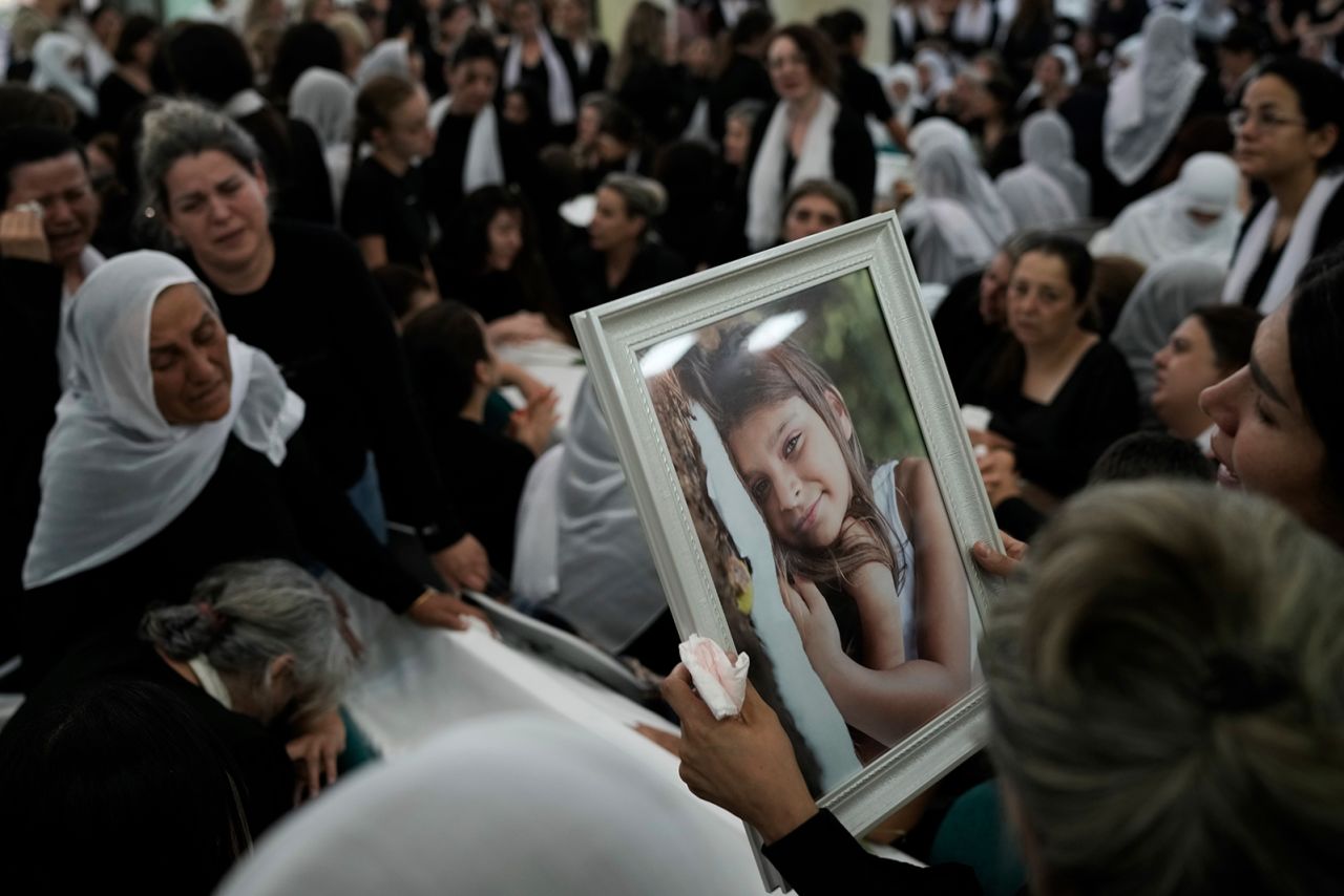 Members of the Druze minority hold a photo of Alma Fakhr al-Din at her funeral on July 28.